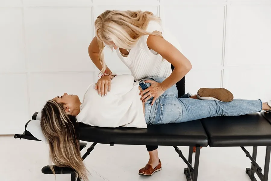 Chiropractor Coon Rapids MN Kayla Naess Adjusting Back