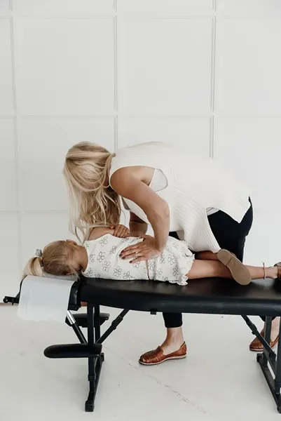 Chiropractor Coon Rapids MN Kayla Naess Adjusting Young Girl