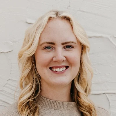 Chiropractor Rae Beaver Smiling In Tan Sweater